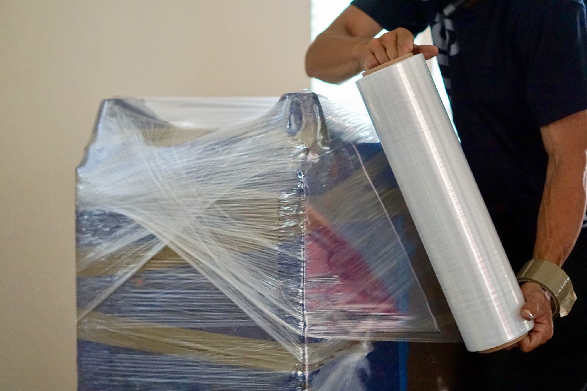 Furniture being wrapped in plastic before moving and storage